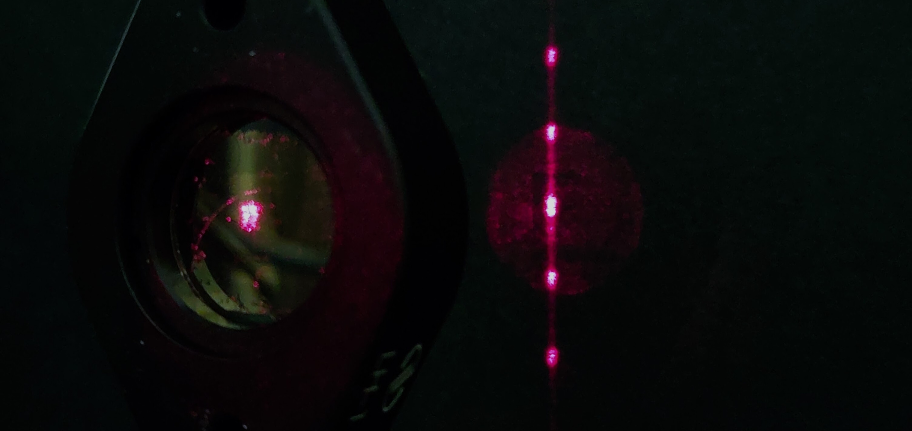 Grating in action, producing a diffraction pattern with a red laser