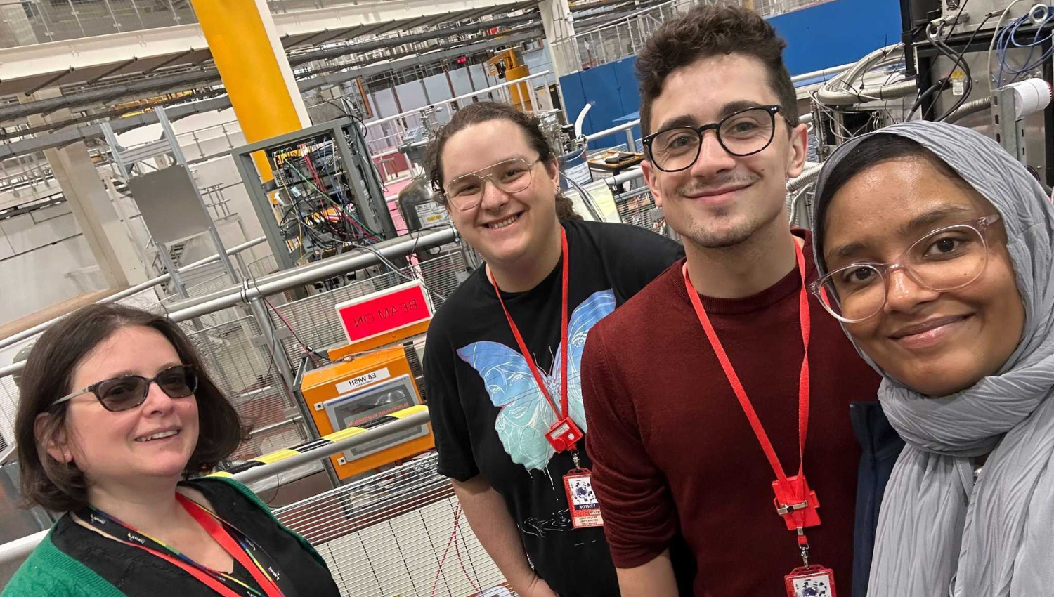 group of people in front of scientific equipment
